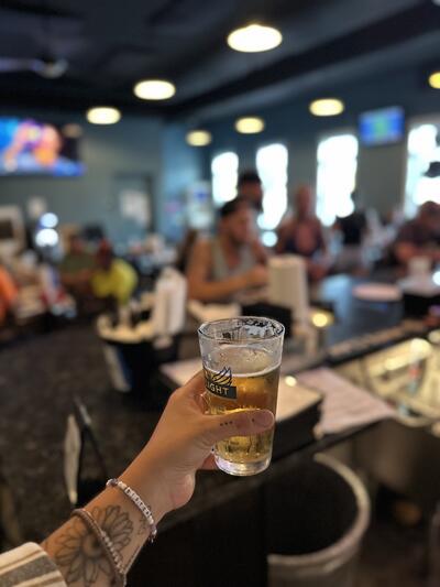 Friends cheersing beers at The Airport Inn